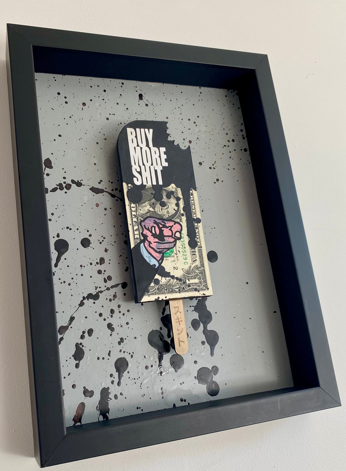 the AXIOMATIC point - Buy More Shit. Finger Pointing Black Lolly.